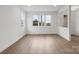 Expansive living room features wood-look floors and abundant natural light through large windows and a view outside at 8078 Blackwood Rd, Denver, NC 28037