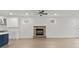 Cozy living room features a stone fireplace, natural light, and a modern ceiling fan at 8078 Blackwood Rd, Denver, NC 28037