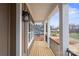 Covered porch with wooden flooring and black railing at 8078 Blackwood Rd, Denver, NC 28037