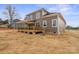 The rear exterior boasts a cozy covered porch, neutral colors, and an inviting outdoor space at 8078 Blackwood Rd, Denver, NC 28037