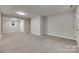 Large carpeted basement room with neutral walls at 109 Belton Ave, Mount Holly, NC 28120