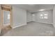 Open floor plan basement with gray walls and carpet at 109 Belton Ave, Mount Holly, NC 28120