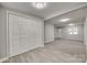 Basement with gray walls, vinyl flooring, and white closet doors at 109 Belton Ave, Mount Holly, NC 28120