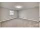 Spacious bedroom with grey carpet and a single window at 109 Belton Ave, Mount Holly, NC 28120