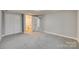 Grey carpeted bedroom with access to a full bath at 109 Belton Ave, Mount Holly, NC 28120