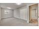 Well-lit bedroom with grey carpet and closet at 109 Belton Ave, Mount Holly, NC 28120