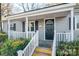 Gray house with white trim, covered porch, and manicured landscaping at 109 Belton Ave, Mount Holly, NC 28120