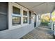 Wooden front porch with gray siding and white railings at 109 Belton Ave, Mount Holly, NC 28120