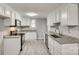 Modern kitchen with white cabinets, granite counters, and stainless steel appliances at 109 Belton Ave, Mount Holly, NC 28120
