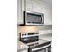 Stainless steel microwave and range in updated kitchen at 109 Belton Ave, Mount Holly, NC 28120