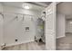 Small laundry room with water heater and shelving at 109 Belton Ave, Mount Holly, NC 28120