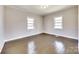 Bright bedroom with hardwood floors and natural light from two windows at 122 Quinn Ave, Gastonia, NC 28054