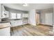 Bright kitchen with white cabinets, modern countertops, and stylish light wood flooring at 122 Quinn Ave, Gastonia, NC 28054