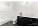 Modern bathroom with hexagon tile floor and dark vanity at 130 Cherokee Rd # 304, Charlotte, NC 28207