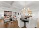 Open concept dining area with modern chandelier and hardwood floors at 130 Cherokee Rd # 304, Charlotte, NC 28207