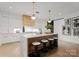 Modern kitchen with white cabinetry, large island, and gold accents at 130 Cherokee Rd # 304, Charlotte, NC 28207