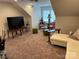 Spacious bonus room with large TV, comfortable seating, and natural light at 1330 Millview Ln, Matthews, NC 28104