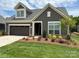 Gray house with brown garage door and landscaping at 1330 Millview Ln, Matthews, NC 28104