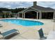 Community swimming pool with lounge chairs and a covered patio at 1330 Millview Ln, Matthews, NC 28104