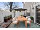 Patio with wooden dining set and potted plants at 15430 Jade St, Charlotte, NC 28277