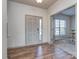 Light-filled entryway with wood-look floors and neutral color palette at 18015 Flowering Oak Ct, Charlotte, NC 28278