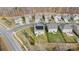 Aerial view of a neighborhood featuring a two-story home with solar panels in the center at 2006 Houle Ln, Charlotte, NC 28214