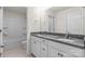 Bathroom featuring double sinks, granite countertops, white cabinetry, and a tub/shower combo at 2006 Houle Ln, Charlotte, NC 28214