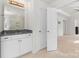 Bathroom leading to the main bedroom has white cabinets and stone countertops at 2006 Houle Ln, Charlotte, NC 28214