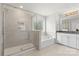 Elegant bathroom features a glass enclosed shower, soaking tub, and granite countertops at 2006 Houle Ln, Charlotte, NC 28214