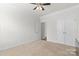 Bright bedroom with neutral walls, carpet floors, and ample closet space at 2006 Houle Ln, Charlotte, NC 28214