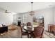 Cozy dining area features a decorative chandelier, a fireplace, and views of the backyard at 2006 Houle Ln, Charlotte, NC 28214