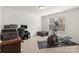 Versatile room features exercise equipment, a desk setup, and a cozy ottoman near the window at 2006 Houle Ln, Charlotte, NC 28214