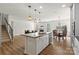Open-concept kitchen with island and stainless appliances, flowing into the dining and living area at 2006 Houle Ln, Charlotte, NC 28214