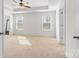 Bright main bedroom features neutral carpeting, a ceiling fan, and windows providing natural light at 2006 Houle Ln, Charlotte, NC 28214