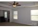 Bright main bedroom with two windows and seating area at 2006 Houle Ln, Charlotte, NC 28214