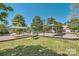 Community playground with shaded areas and play structures at 2006 Houle Ln, Charlotte, NC 28214
