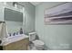 Bright powder room featuring neutral walls and decorative mirror at 203 Riverview Ter, Clover, SC 29710