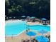 Inviting community pool area with lounge chairs, umbrellas, and plenty of space for relaxation and recreation at 203 Riverview Ter, Clover, SC 29710