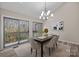 Bright dining room with wood floors, stylish lighting, and sliding door access to balcony at 203 Riverview Ter, Clover, SC 29710