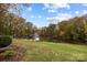 Scenic lake view home featuring mature trees and a peaceful waterfront setting with a gentle sloping lawn at 203 Riverview Ter, Clover, SC 29710