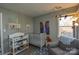 Bright Bedroom featuring a crib, changing station, and comfortable armchair at 2313 Linda Lou Ct, Charlotte, NC 28213