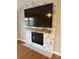 Modern fireplace with a large TV above and stone surround at 2411 Sutters Rd, Concord, NC 28027