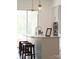 Kitchen island with modern pendant lights and barstools and stainless steel double ovens at 2530 Park Rose Ln # 12, Charlotte, NC 28204