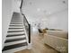 Open concept living room and kitchen with hardwood floors and modern lighting at 2530 Park Rose Ln # 12, Charlotte, NC 28204