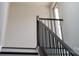 Contemporary staircase with dark metal railing and wood stairs, providing access to upper levels at 2530 Park Rose Ln # 12, Charlotte, NC 28204