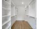 Large walk-in closet with ample shelving and hardwood floors; perfect for organization at 2530 Park Rose Ln # 12, Charlotte, NC 28204