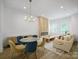 An open concept living room area and dining room featuring modern design and neutral color palettes at 2534 Park Rose Ln # 11, Charlotte, NC 28204
