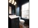 Stylish powder room with a modern vanity, sleek fixtures, and contrasting dark walls and trim at 2538 Park Rose Ln # 10, Charlotte, NC 28204
