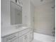 Modern bathroom featuring a sleek vanity, bathtub with tile surround and overhead lighting at 2538 Park Rose Ln # 10, Charlotte, NC 28204