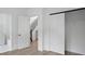 Bright bedroom with white trim, open doorways, closet with sliding door and hardwood floors at 2538 Park Rose Ln # 10, Charlotte, NC 28204